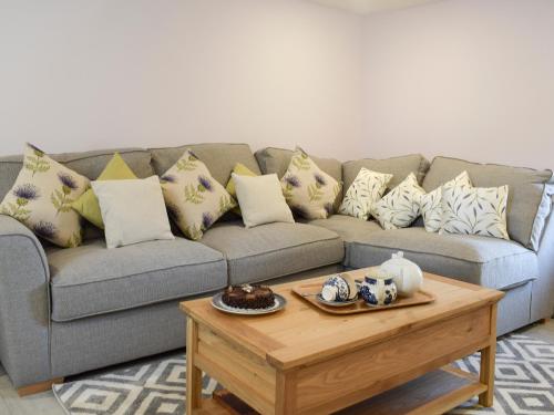 a living room with a couch and a coffee table at Rowanlea in Muthill