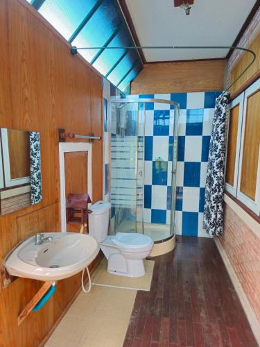 a bathroom with a toilet and a shower and a sink at The Florist Ayutthaya in Phra Nakhon Si Ayutthaya