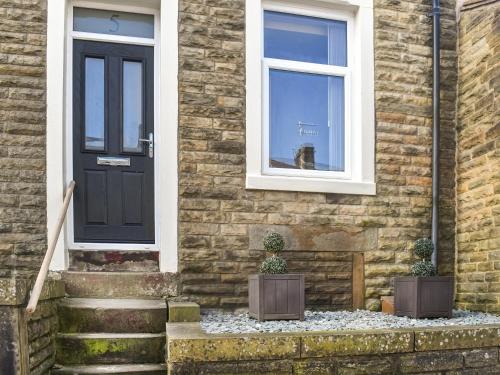 a dog looking out the window of a house at Hollingreave House in Burnley