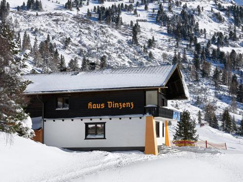 a building with a sign on it in the snow at Haus Vinzenz in Obertauern