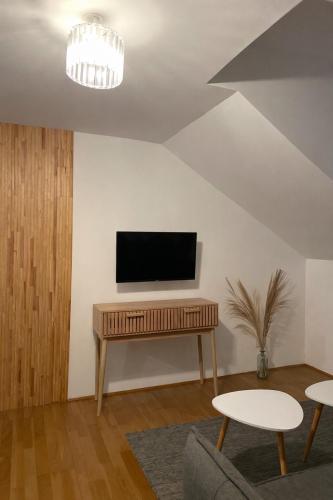 a living room with a television on a table at Troisieme du nom in Nevers