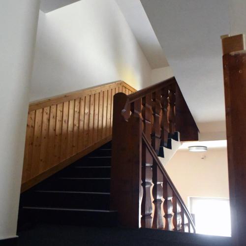 a staircase in a building with a wooden railing at Haus Vinzenz in Obertauern