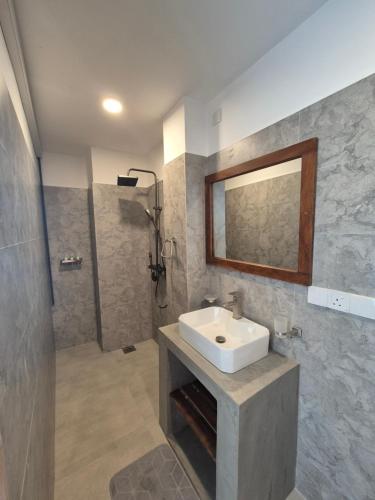 a bathroom with a sink and a shower at Sky Bloom Ahangama in Ahangama