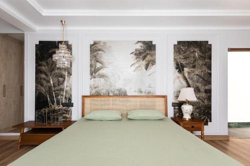 a bedroom with a large bed and a chandelier at Entire 4bhk villa in Panchkula, Chandigarh in Panchkula