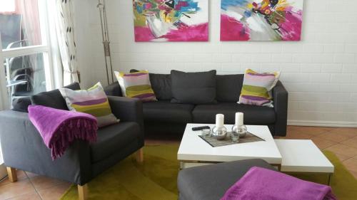 a living room with a couch and a table at Marinapark Scharmützelsee in Wendisch Rietz