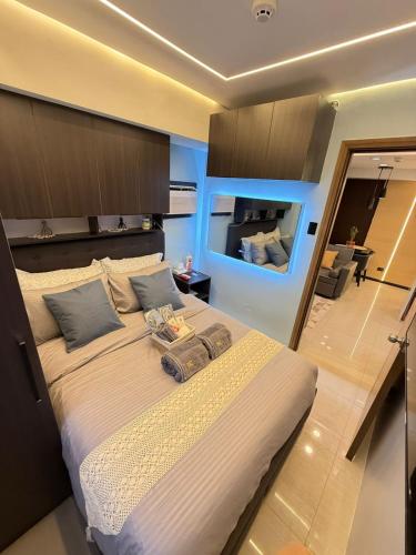 a bedroom with a large bed in a room at LM50L2 horizon101 cebu in Cebu City