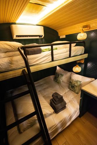 a room with two bunk beds and a desk at Baan Rot Fai Krabi Platform 2 in Ao Nam Mao
