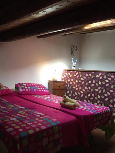 a teddy bear sitting on a bed in a bedroom at A casa da Titta in San Martino dʼAgri