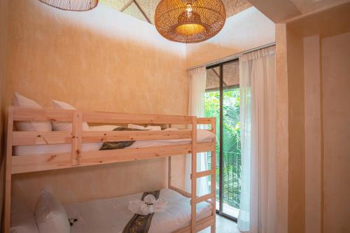 a bedroom with two bunk beds and a window at SeaTara Resort in Ko Phangan