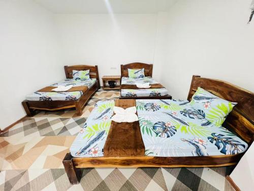 two beds in a room with two at Panda Guest House in Coron