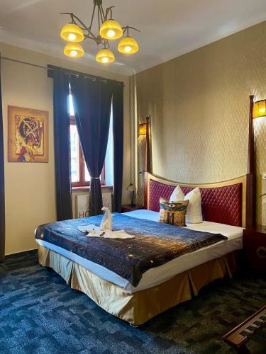 a hotel room with a large bed in a room at Wellness Hotel Beethoven in Chomutov
