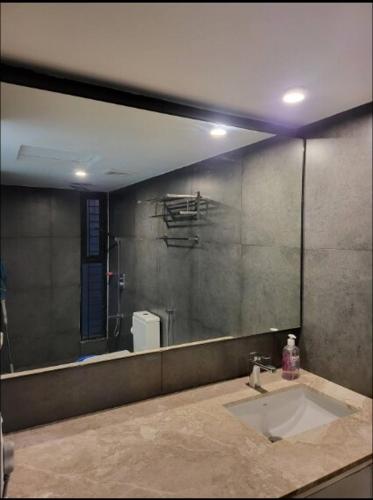 un bagno con un lavandino e un grande specchio di 1BR Studio with Rooftop Access a Dhaka