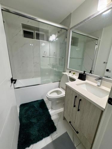 a bathroom with a toilet and a sink and a shower at Comfort 2 BR Vancouver! in Vancouver