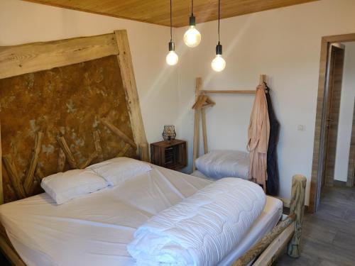 a bedroom with two beds and two lights at Appartement Terrasse Jacuzzi du Pont Alsort 2-2 in Froid-Chapelle