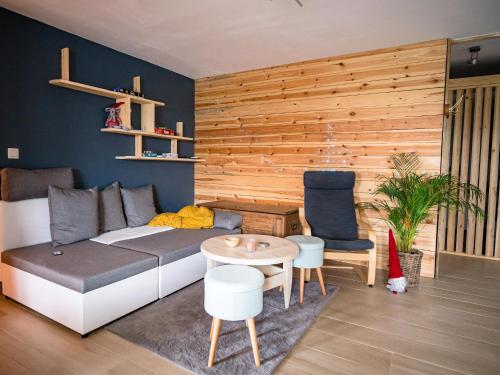 a living room with a couch and a table at Appartement Spa VIP du Pont Alsort 2-3 in Froid-Chapelle