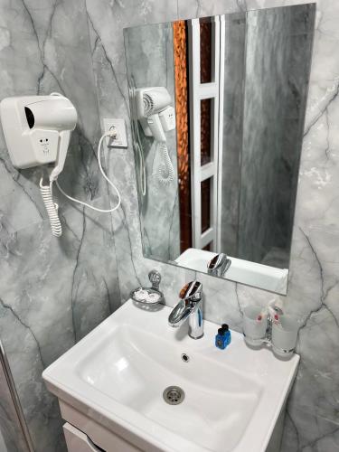 a bathroom with a sink and a mirror at Afruza Hotel in Samarkand