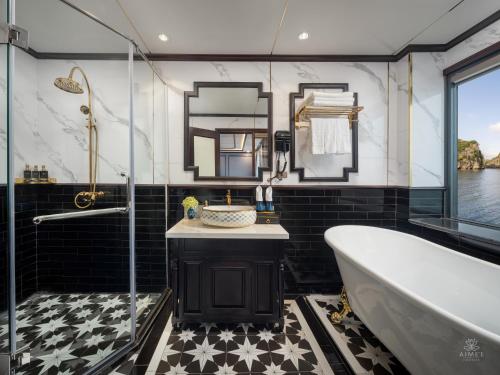 a bathroom with a tub and a sink and a shower at AIME'E CRUISES - Halong Bay in Ha Long
