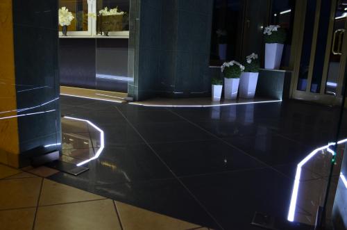 a lobby with lights on the floor of a building at Hotel Podróżnik in Koszuty