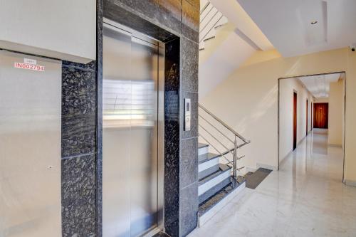 a hallway with a glass door in a building at FabHotel Ayodhya in Pune