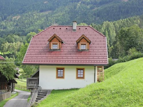 a small house with a red roof on a hill at Peaceful Cottage near Ski Area in Gmünd in Gmünd in Kärnten