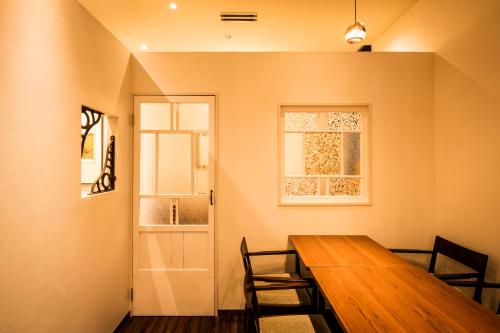 a dining room with a wooden table and chairs at Sotetsu Fresa Inn Ginza-Nanachome in Tokyo