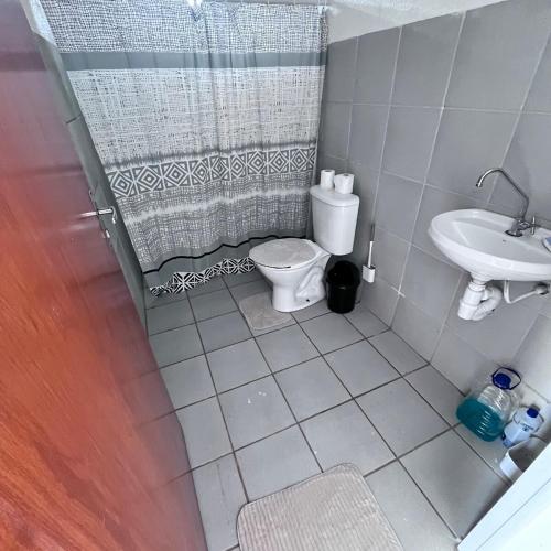 a bathroom with a toilet and a sink at Casa Barreirinhas in Barreirinhas