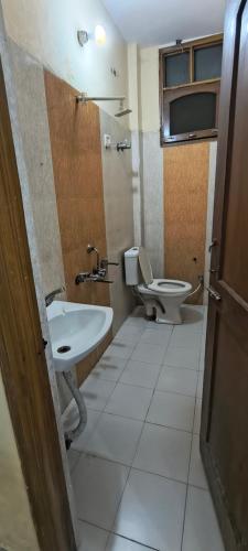 a bathroom with a sink and a toilet at Pb Legacy hotel in Noida