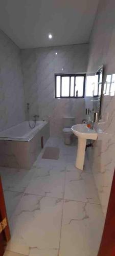a large bathroom with a tub and a sink and a tub at Villa with 4 bedrooms in Lusaka