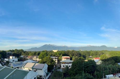 a view of a city with a mountain in the background at Unit 28 Mountain View Studio by Ems in Dumaguete