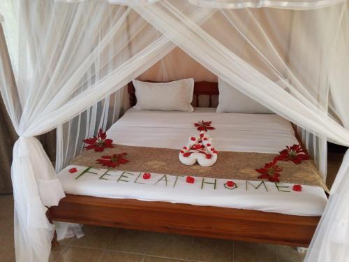 a bed with two christmas decorations on it at Taita Rocks Hotel in Wundanyi
