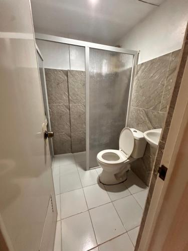 a bathroom with a toilet and a sink at Pietros Square in Butuan