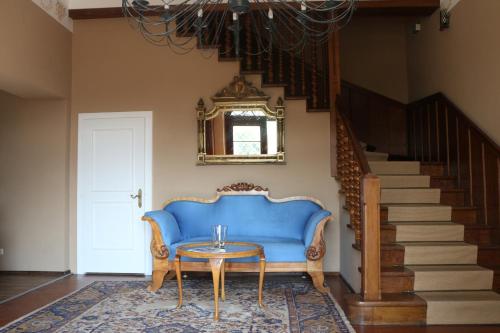 a blue couch in a living room with a table at Residenz am See in Sankt Kanzian