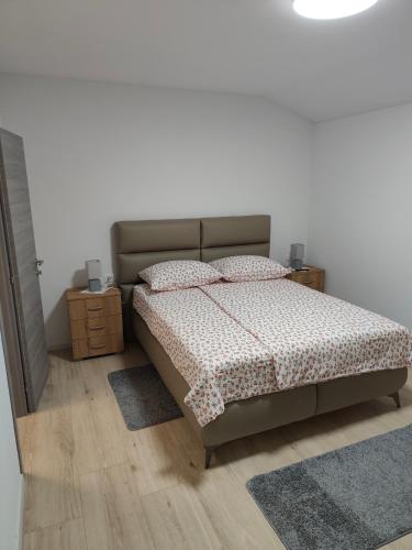 a bedroom with a bed with two pillows on it at Villa Germini in Polje Čepić