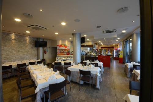 a dining room with white tables and chairs at Kiara Residence in Giulianova