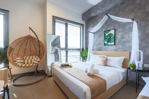 a bedroom with a large bed and a large window at Mossaz Suites by Mana Mana in Petaling Jaya