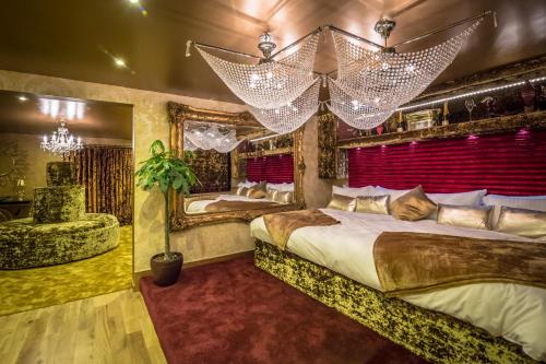 a bedroom with two beds and a red curtain at Who'd A Thought It in Lenham