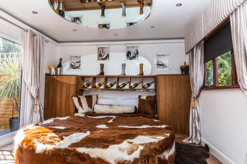 a bedroom with a large bed and a large mirror at Who'd A Thought It in Lenham