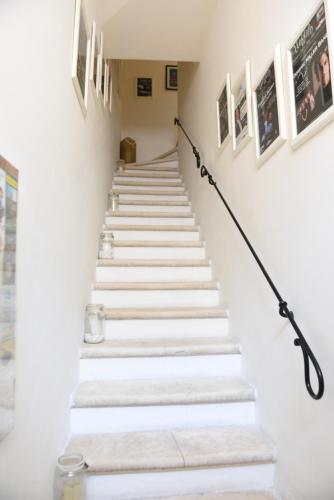 a set of stairs in a hallway with pictures on the walls at B&B Il Grifone in Gioia del Colle