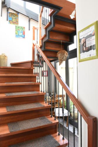 a staircase in a home with wood and metal railings at B&B Il Grifone in Gioia del Colle