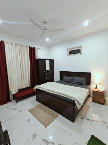 a bedroom with a large bed in a room at BASERAA BIR - A Slow Traveler's Home in Bīr
