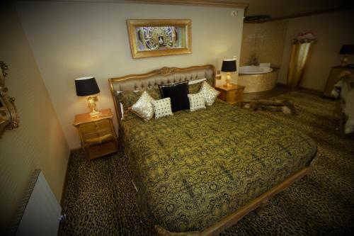 a bedroom with a bed and two night stands with lamps at Who'd A Thought It in Lenham