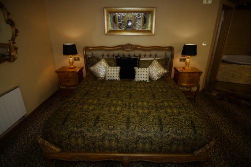 a bedroom with a large bed with two night stands at Who'd A Thought It in Lenham