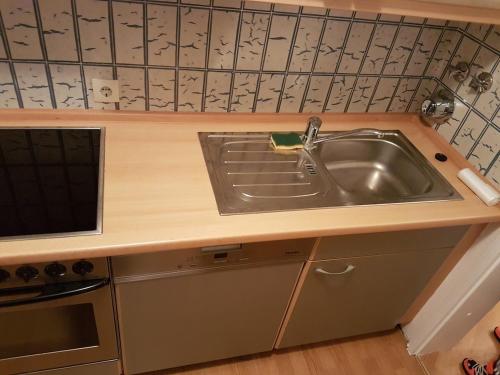 a kitchen with a sink and a counter top at Cosy Accommodation - very central in Munich