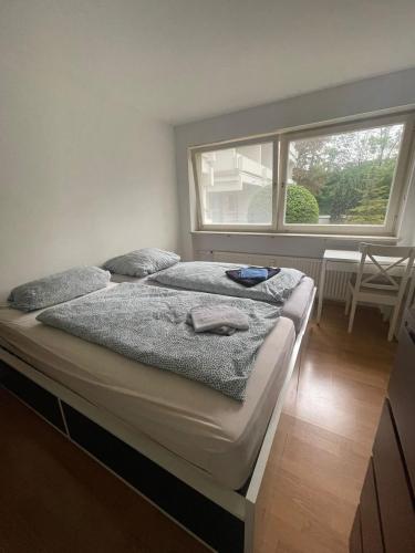 a bed in a room with a large window at Cosy Accommodation - very central in Munich