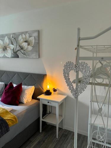 a bedroom with a bed and a table with a heart decoration at Apartment Mona´s Home in Sankt Pankraz