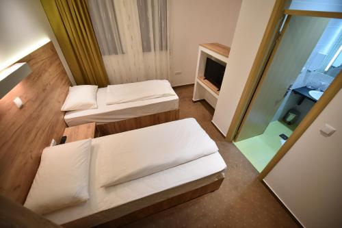 Ένα ή περισσότερα κρεβάτια σε δωμάτιο στο Hotel Tesla