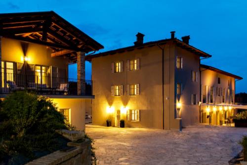 an exterior view of a building at night at Réva Resort in Monforte dʼAlba