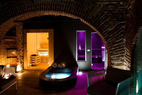 a living room with a couch and a fireplace at Réva Resort in Monforte dʼAlba