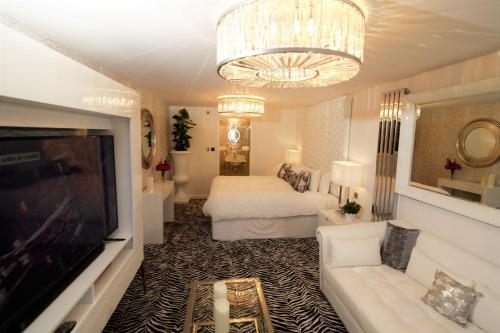a living room with a bed and a television at Who'd A Thought It in Lenham