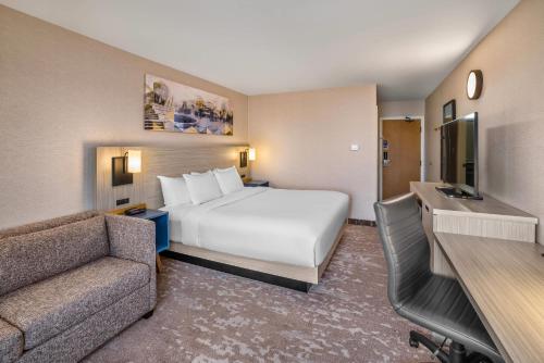 a hotel room with a bed and a couch at Comfort Inn Moncton East in Moncton